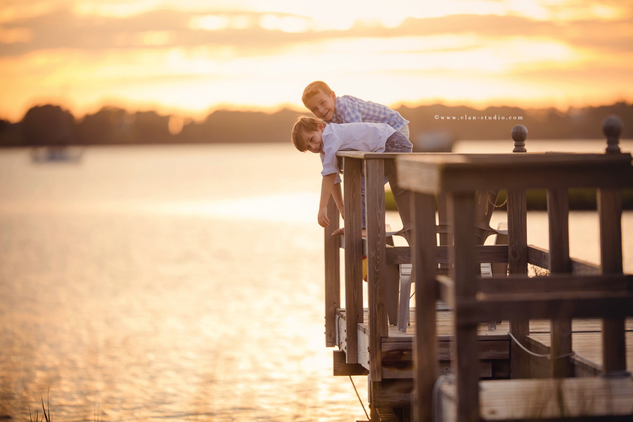 two boys playing on a dock