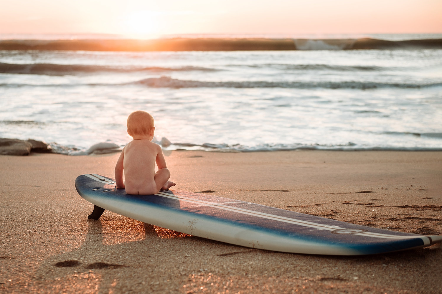 baby boy sitting on a surfboard at sunrise, sunrise baby session, Ryaphotos