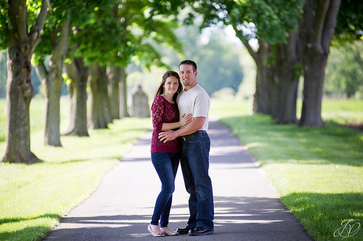 summer engagement photo with row of trees