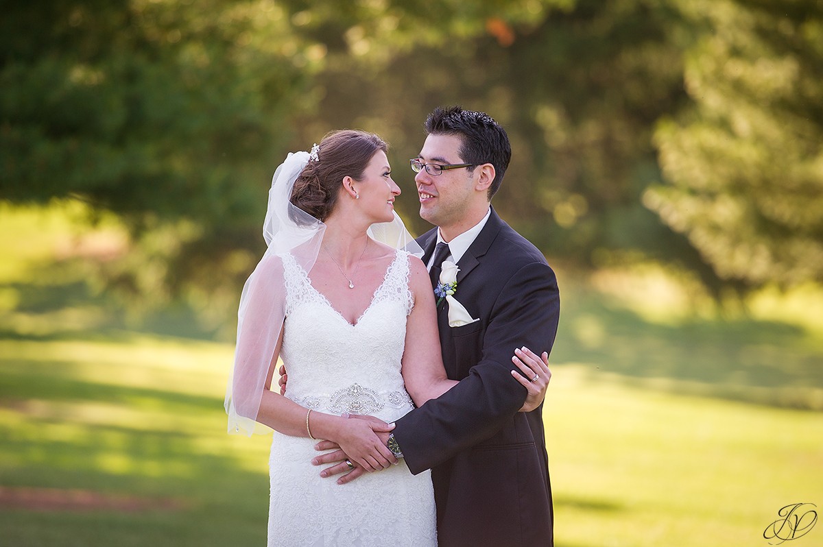 close up of bride and groom on golf course