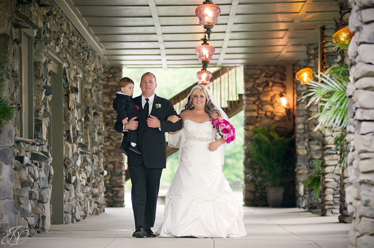 emotional shot of bride being walked down the aisle by father