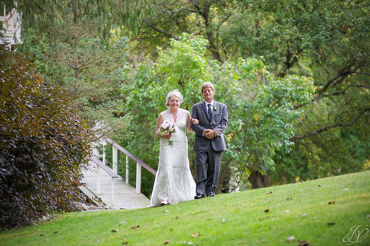 beautiful photo of father walking bride down the aisle