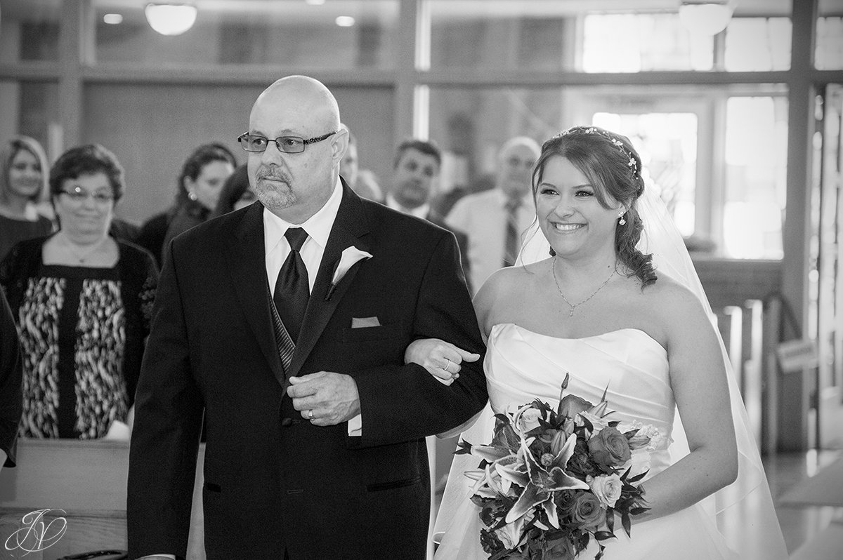 photo of bride walking down aisle with her father