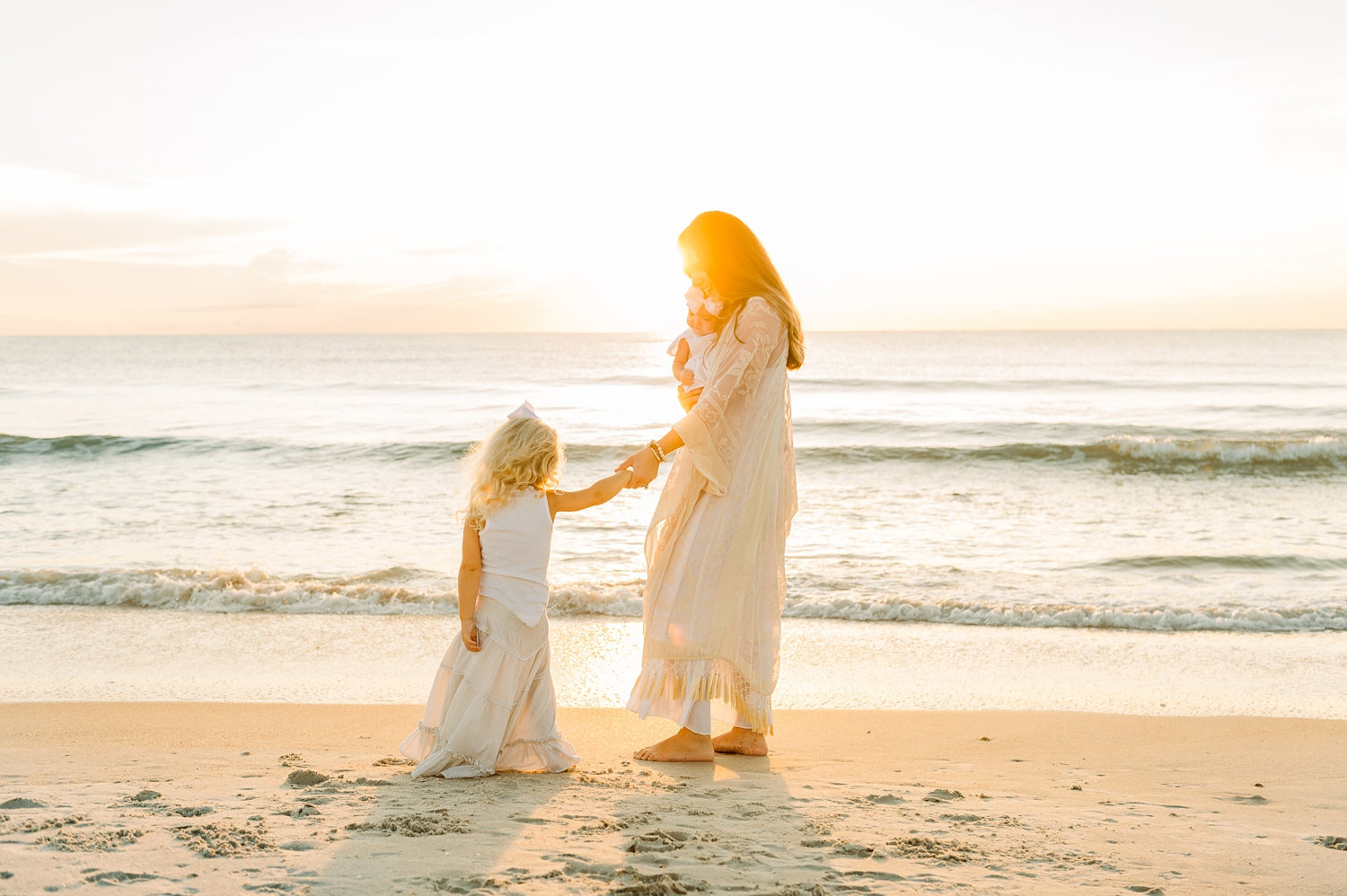 mother holding her little girl's hand, mom is holding a baby girl, Ponte Vedra Beach