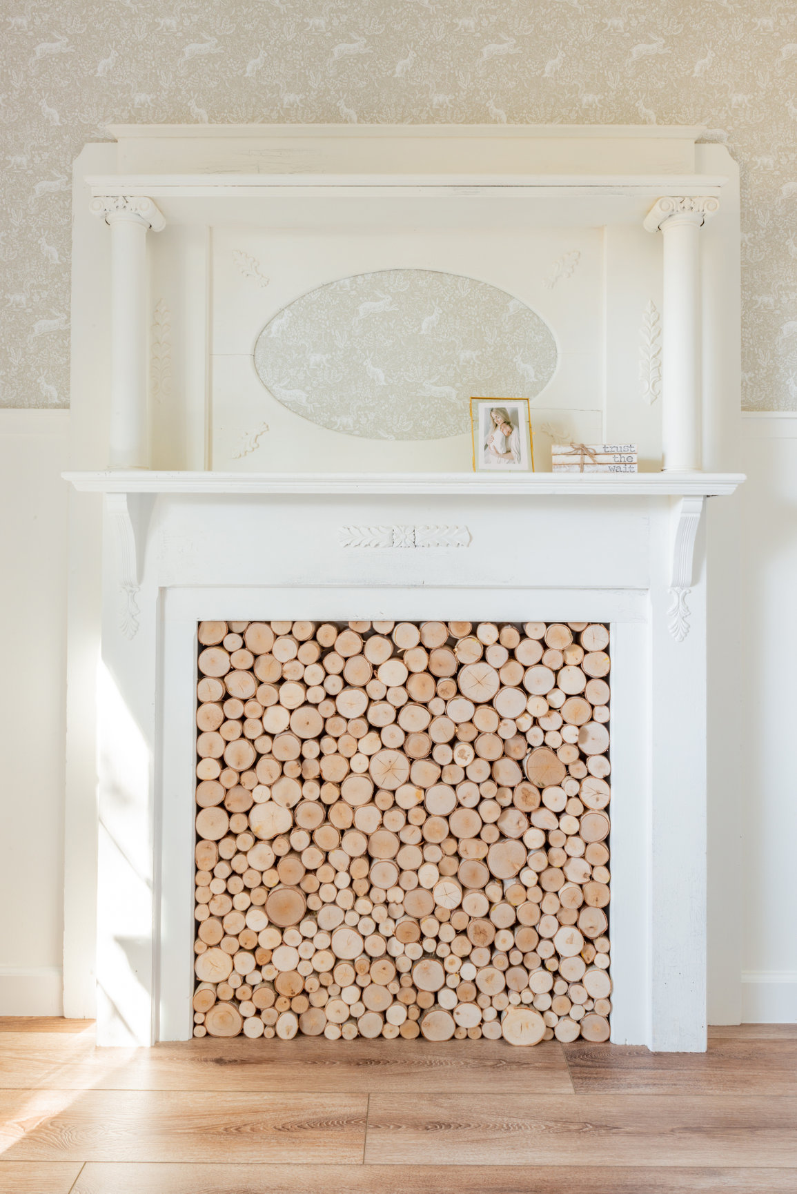 restored Victorian fireplace in a French Farmhouse style nursery, woodland bunny wallpaper