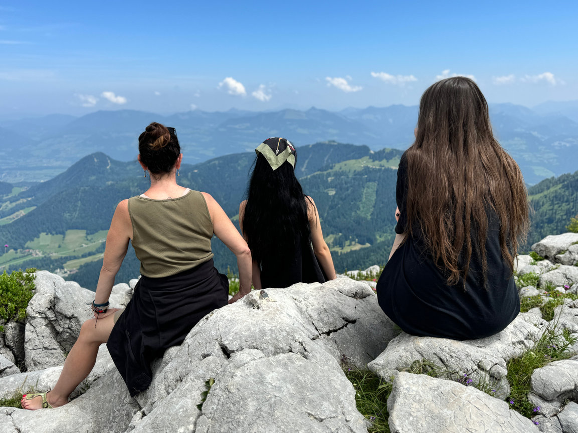 Students attending Swartz Portraits Educational Travel Program sit in the Austrian Alps identifying who the light is transitioning over the area.