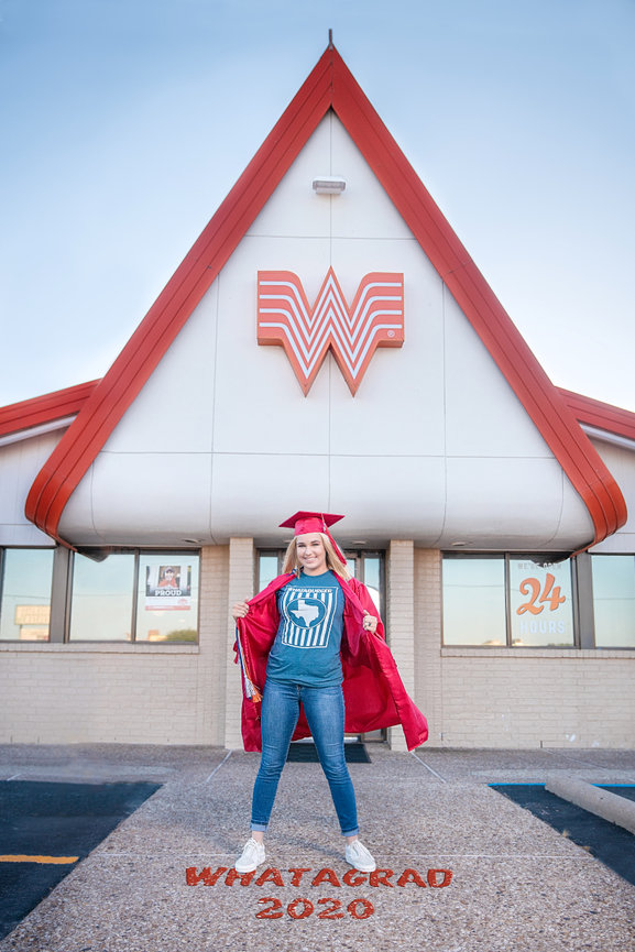 Senior portrait girl cap and gown standing in front of whataburger