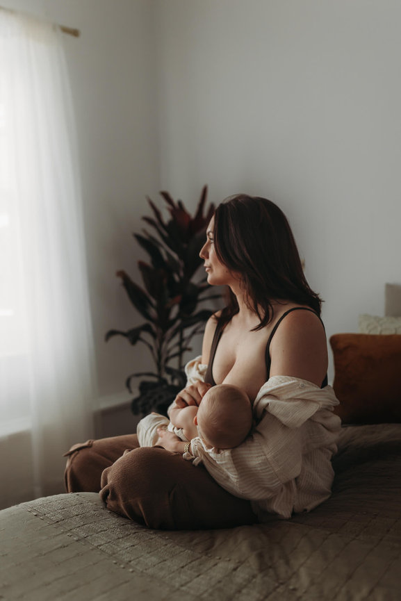 A woman nursing her baby in a photography studio in Mendham, New Jersey.