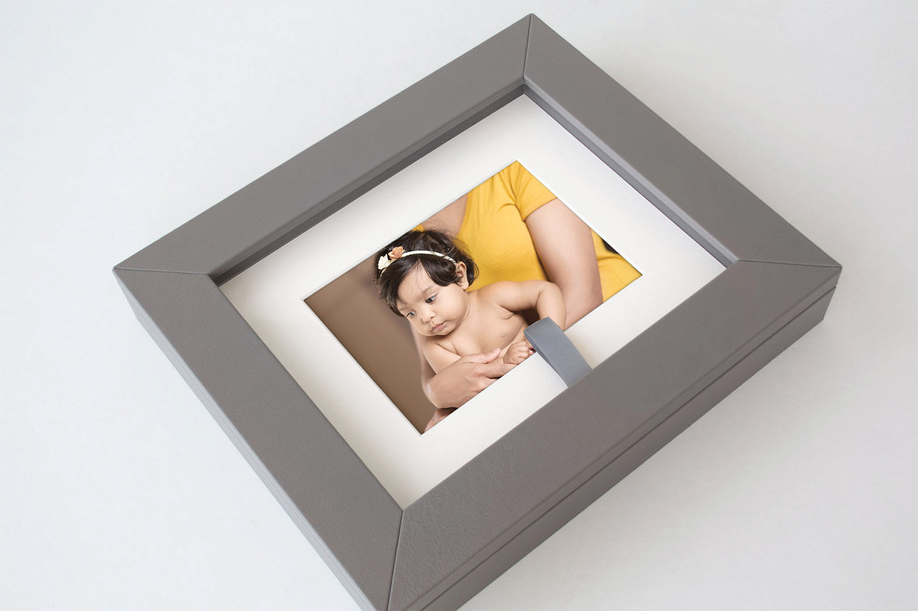 matted baby portrait presented in a folio box with fine art print presentation