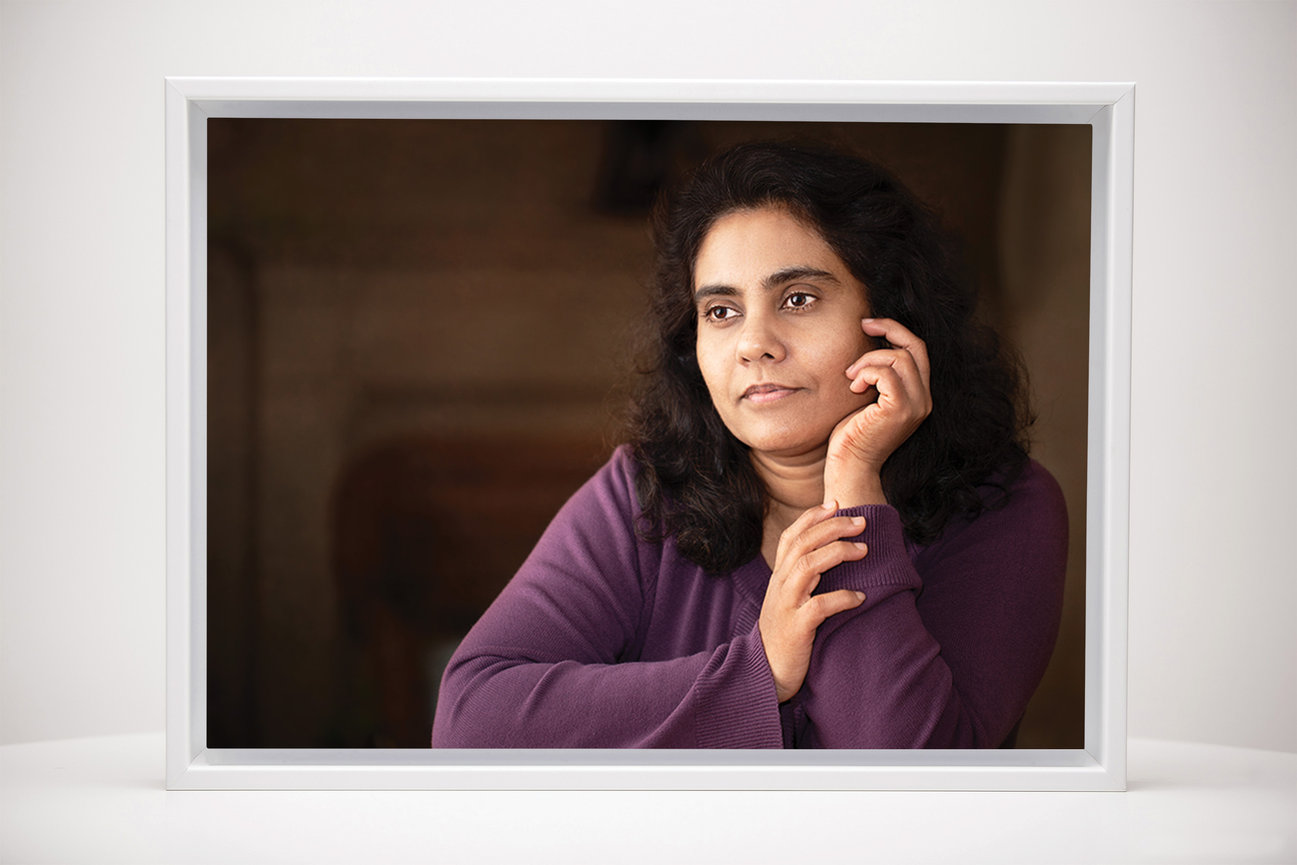 Framed personal portrait print displayed as wall art, featuring a woman with a calm, thoughtful expression, styled to highlight a refined and timeless presentation.