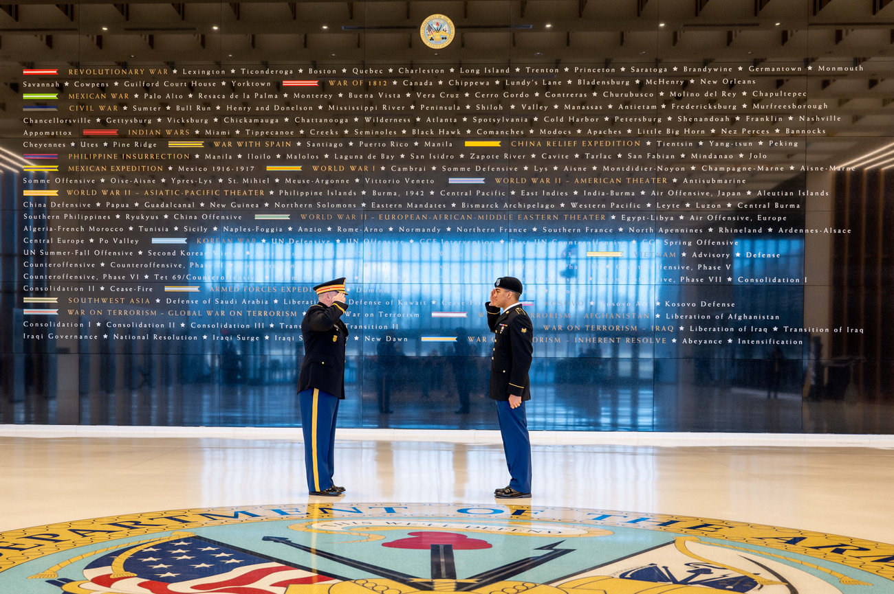 Army officer saluting a junior NCO prior to his retirement ceremony at the National Museum for the United States Army
