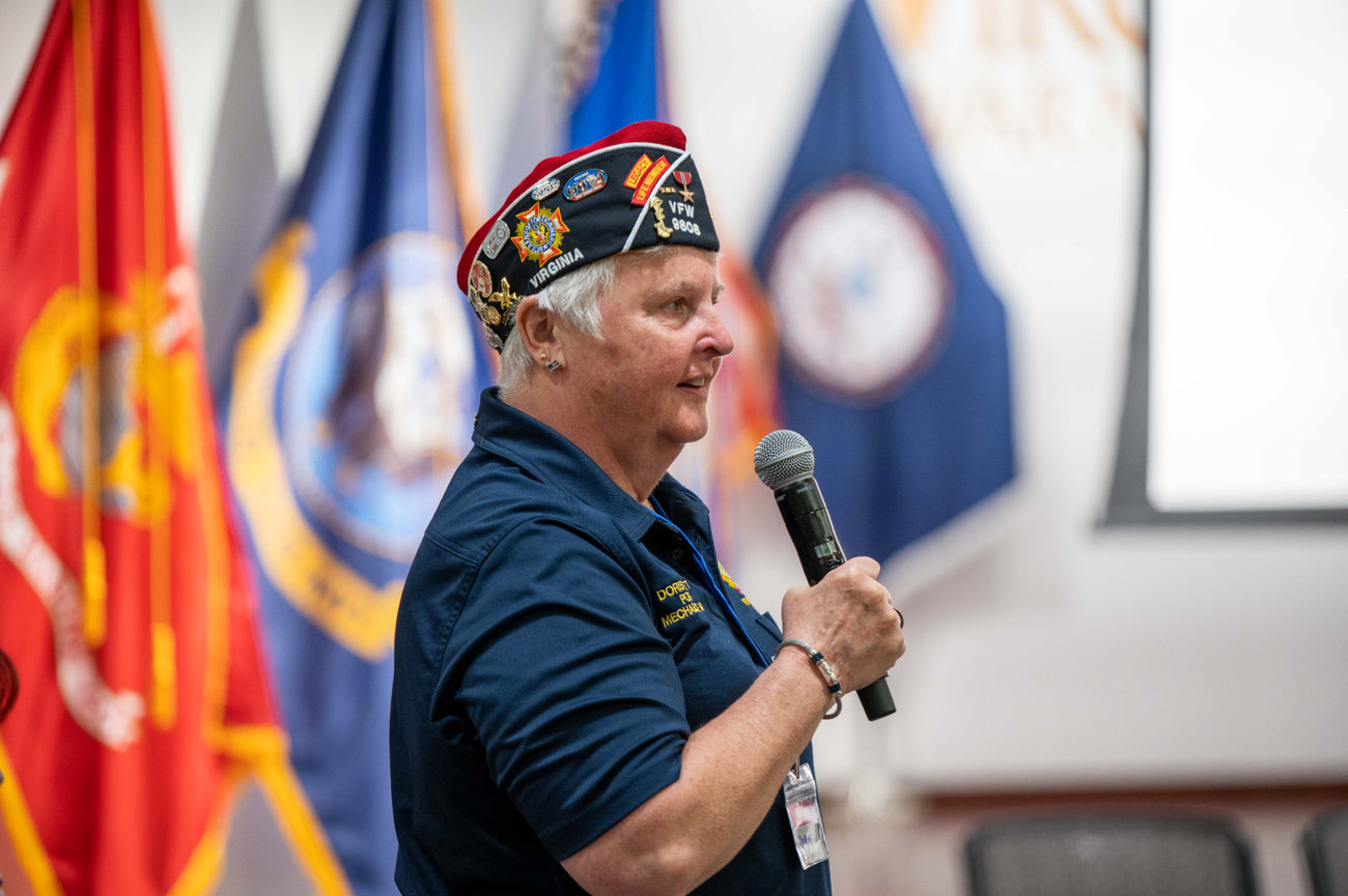 A woman veteran speaking at an event