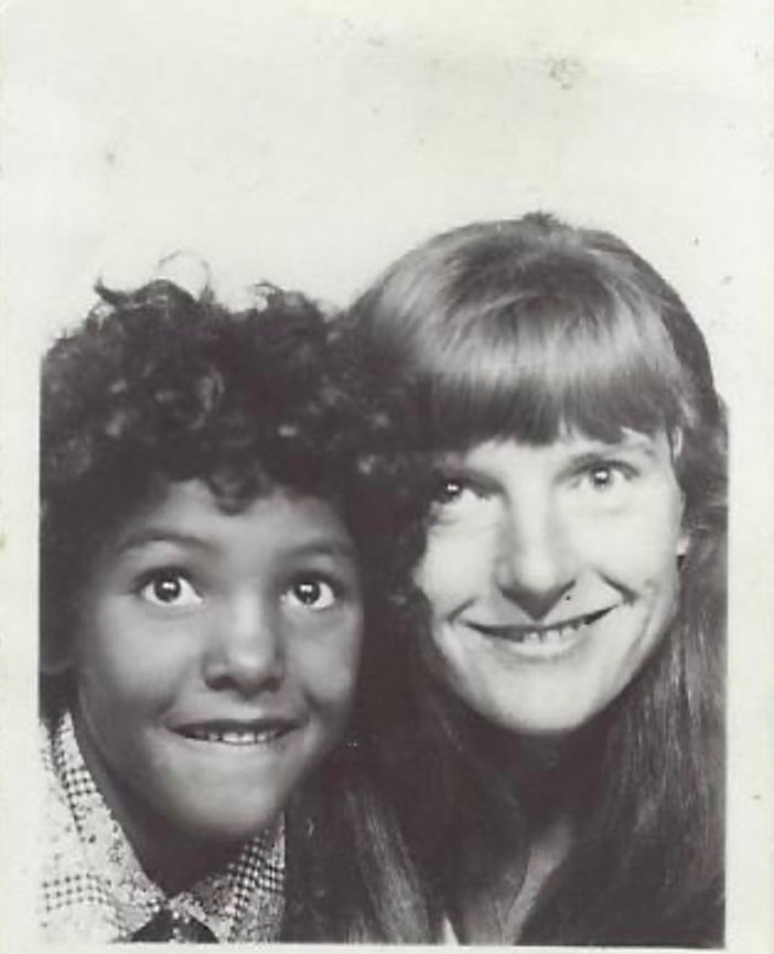 A young Laura Hatcher with short hair and her mother