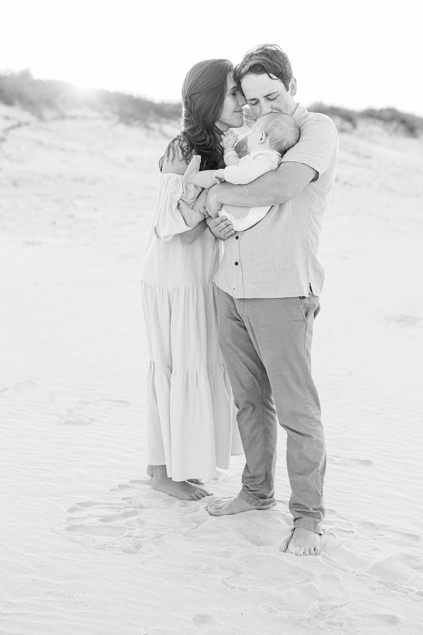 black and white images of family standing together on the beach