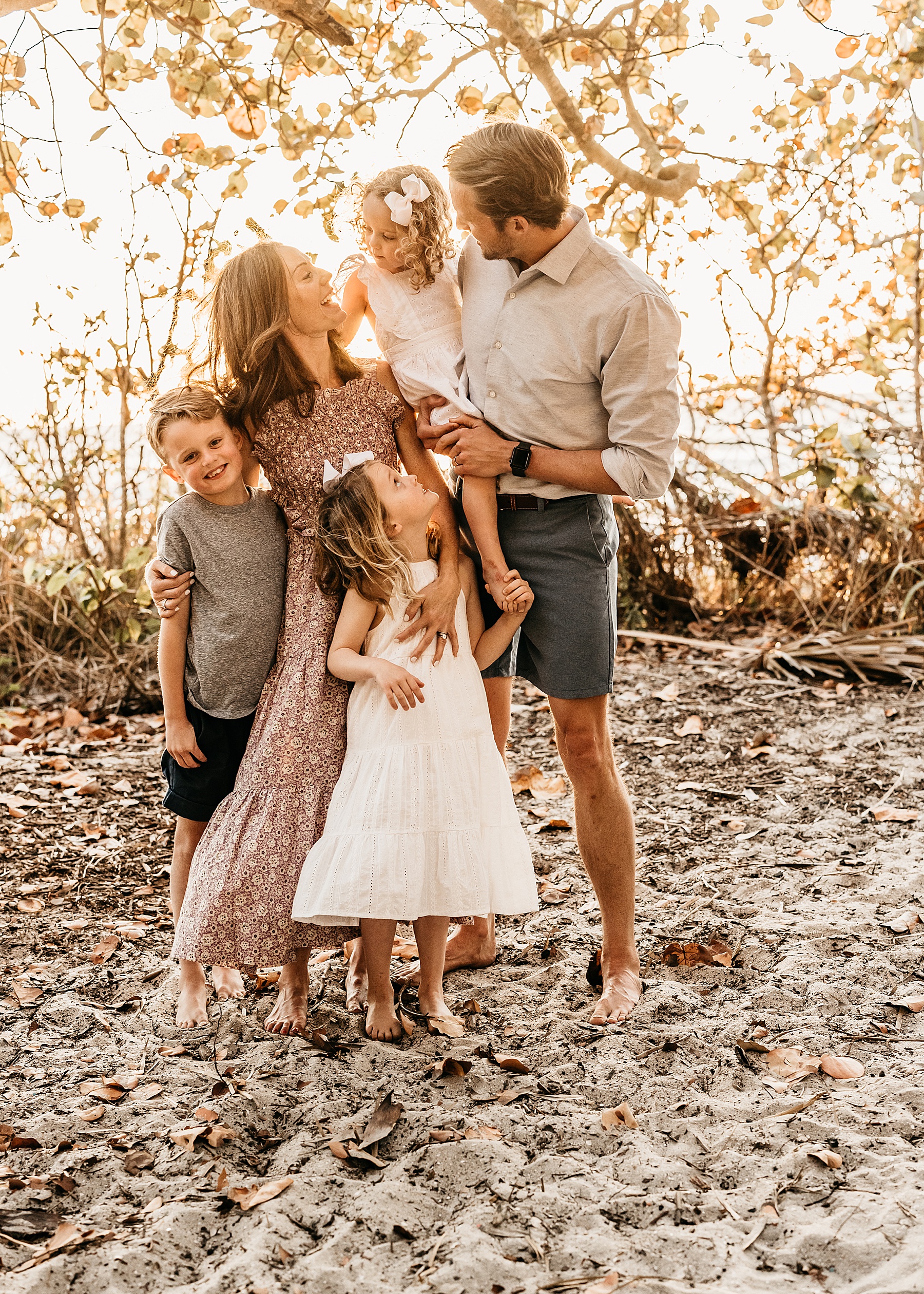 family at sunset on the beach at Wiggins Pass in Naples Florida