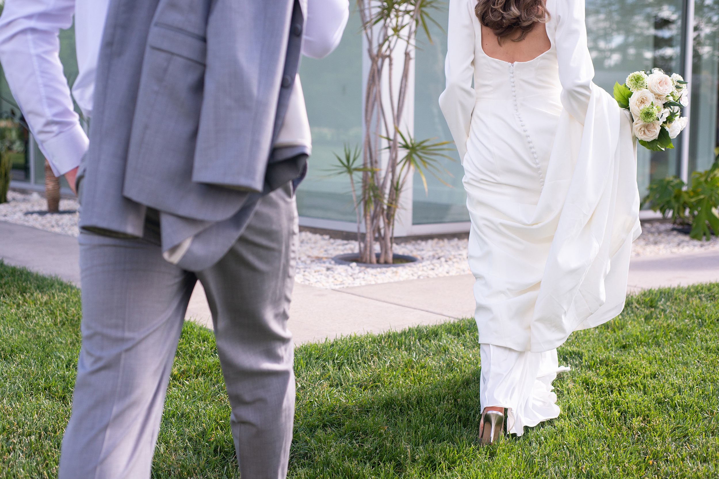 Bride and groom walking to wedding venue near Springfield, Missouri.
