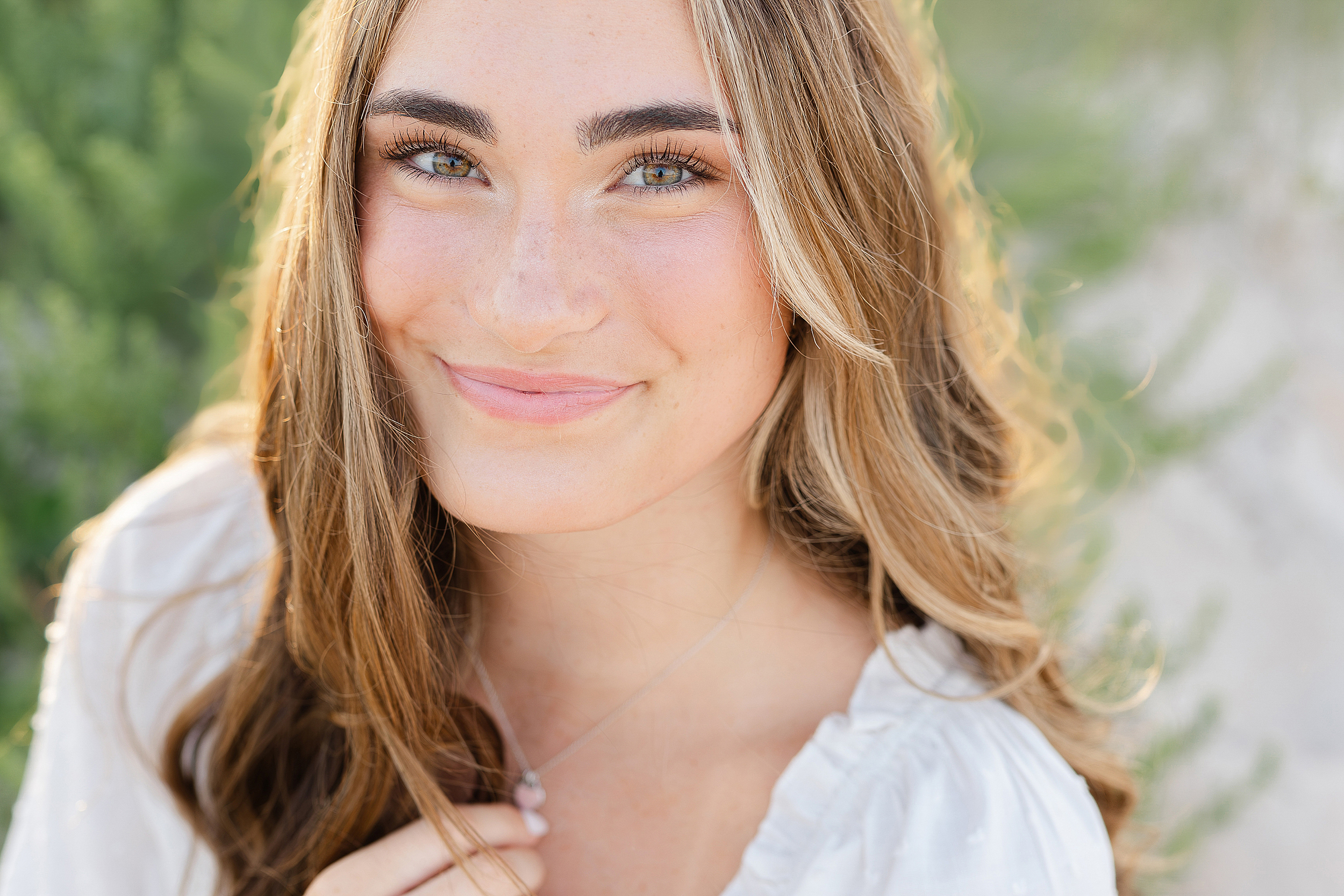 Close up portrait of young woman during a grad photo session.