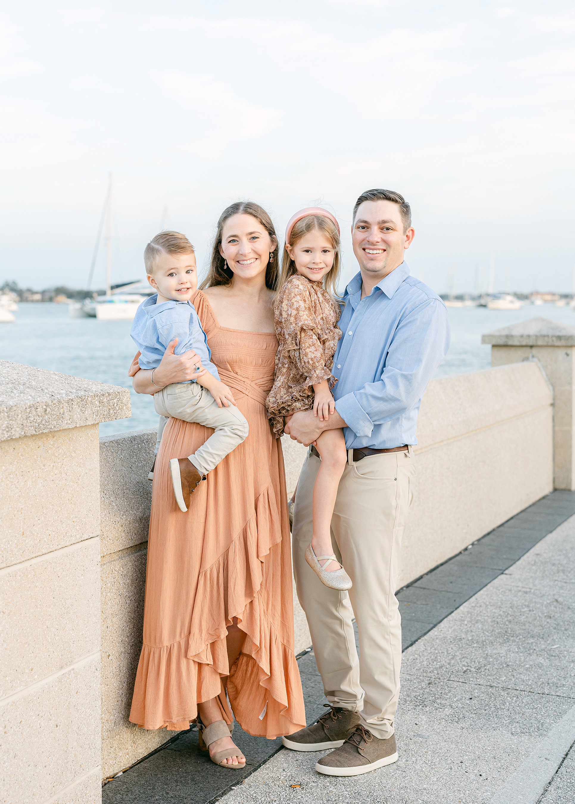 Pastel sunset portrait of a family standing on the wharf in downtown Saint Augustine, Florida.