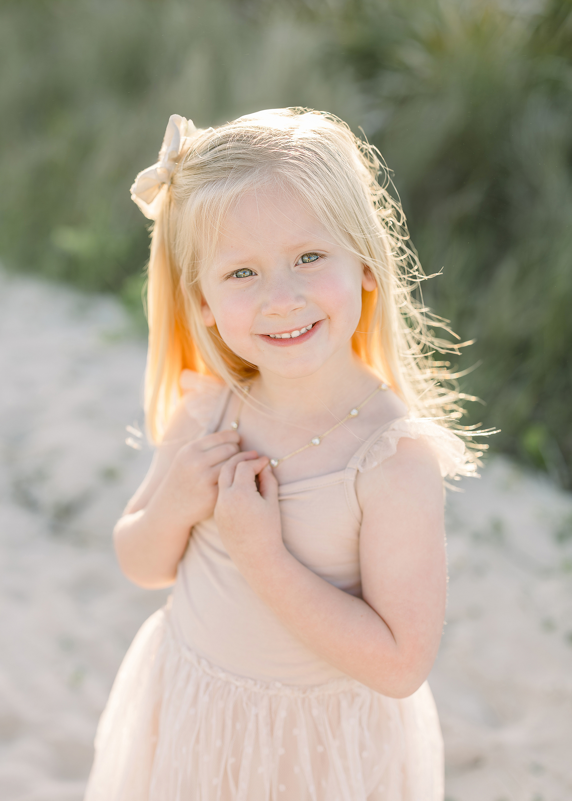 A sunset beach portrait of a little girl on the sand in St. Augustine Beach, Florida.