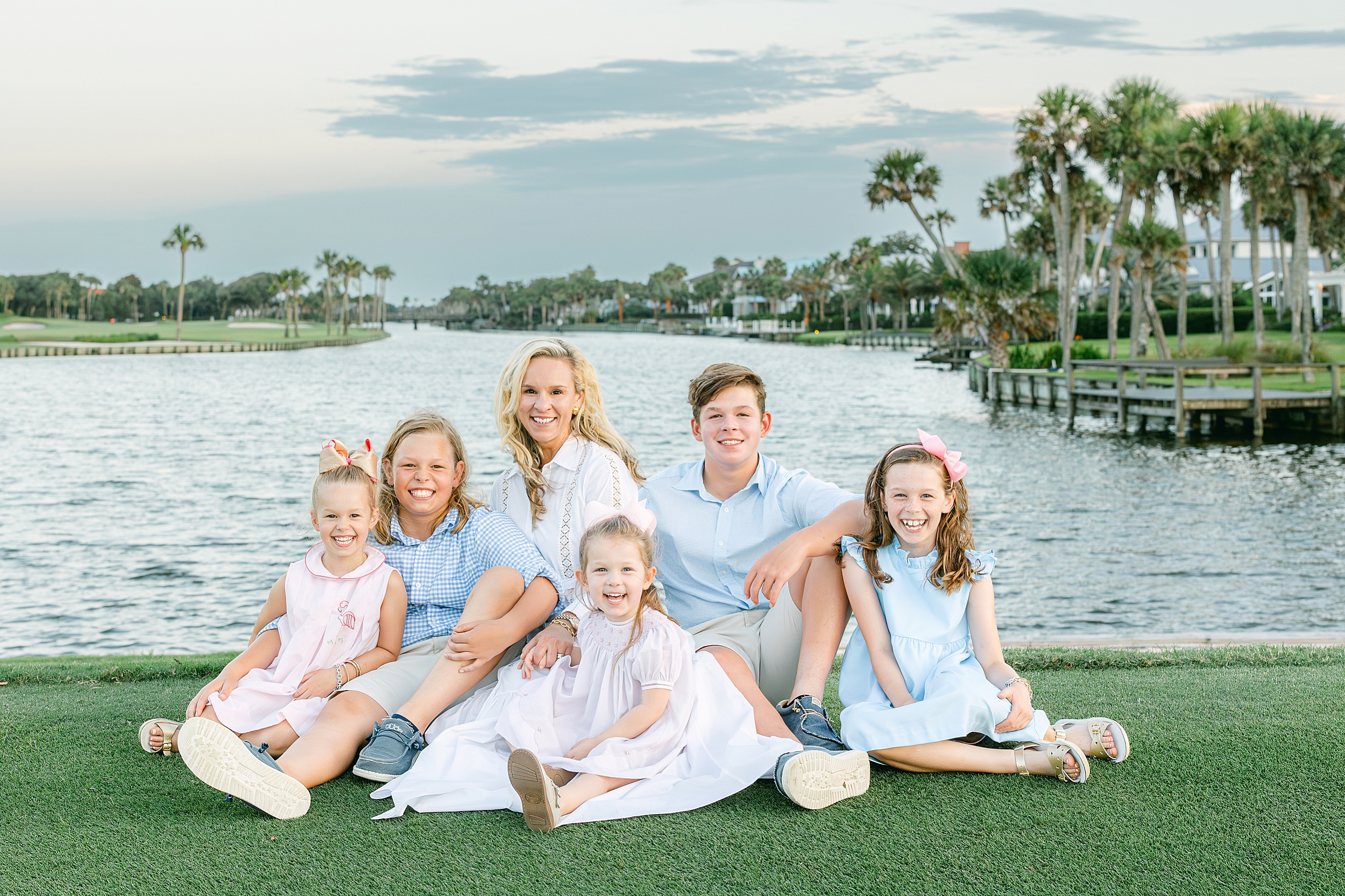 A mother with her children sits on the putting green at Ponte Vedra Inn and Club in Florida.