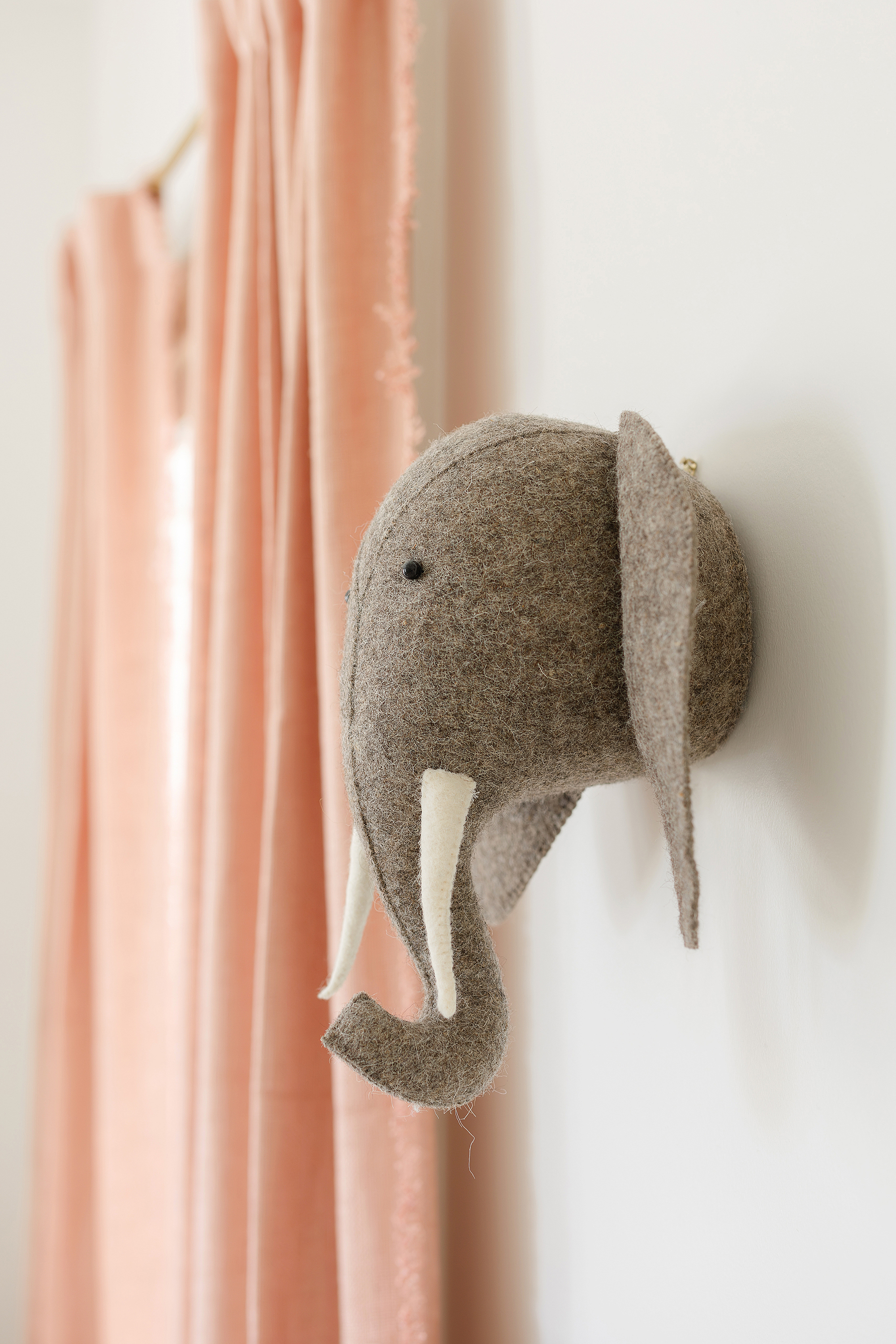 A detail shot of an elephant in a newborn baby girl's nursery.