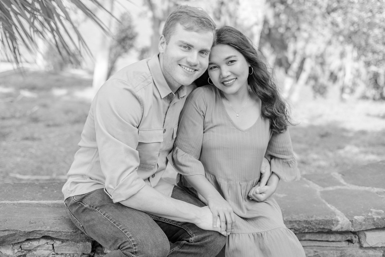 A couple holding hands sitting next to each other in Philippe Park