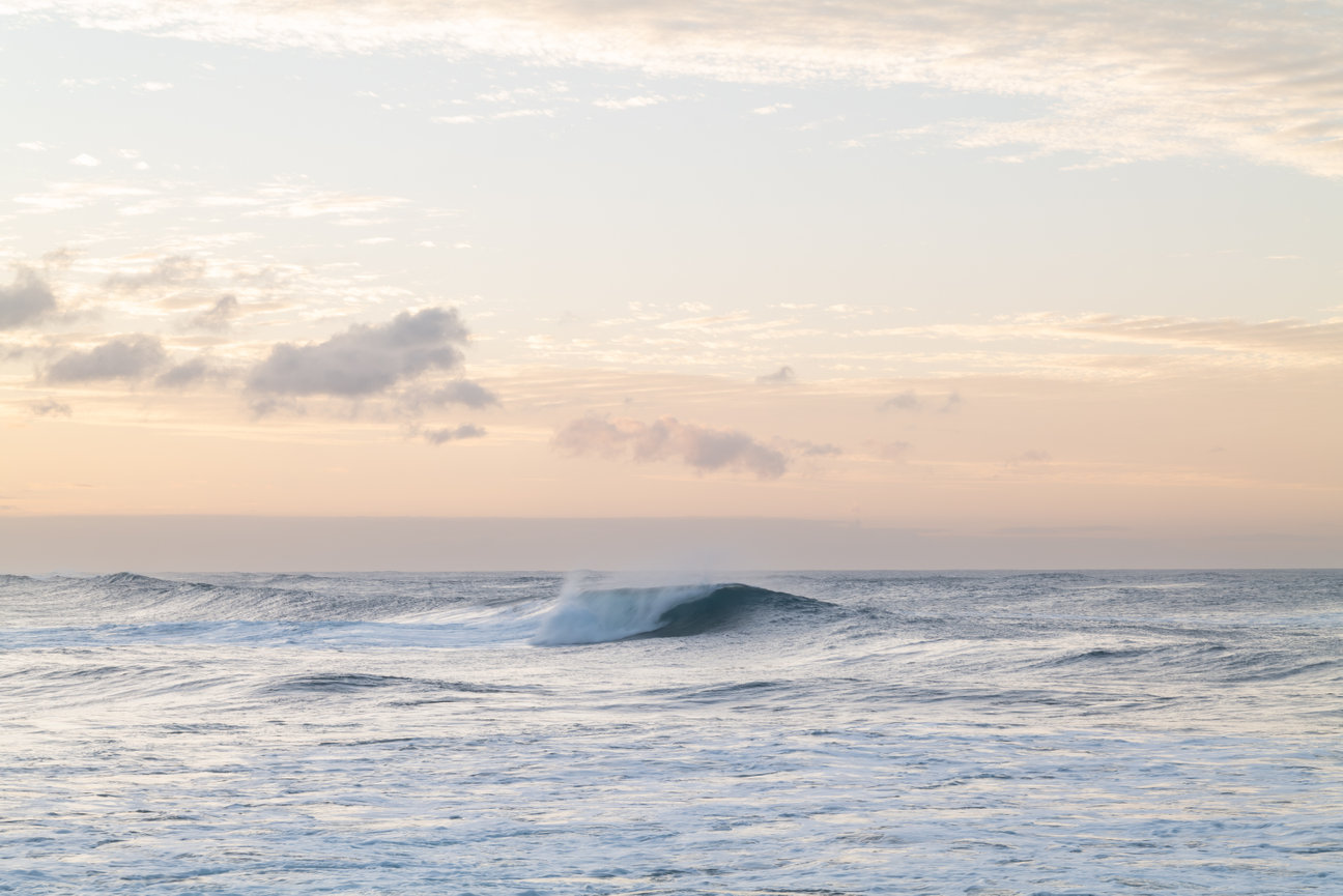 Pacific Curl - minimalist ocean wave photograph by Andrea Bruns capturing a curling Pacific swell in soft golden coastal light.