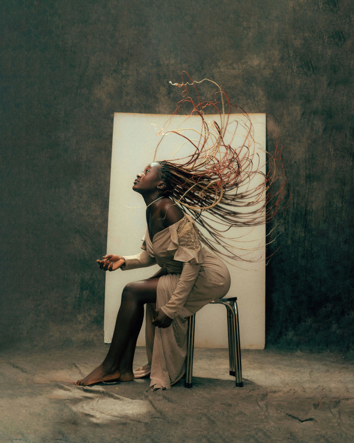 Woman sitting with hair flipping in air