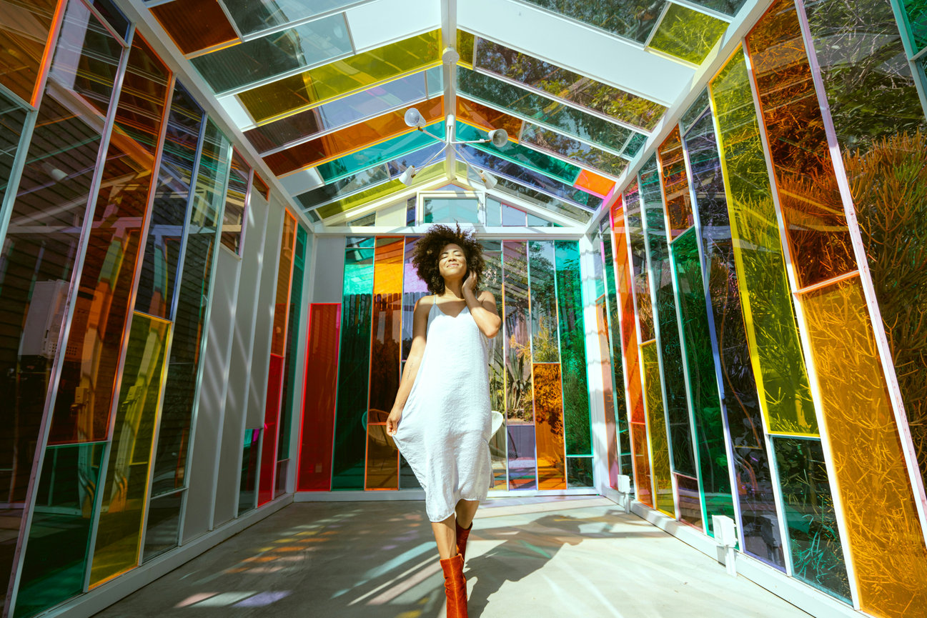 Woman walking in colorful glass structure