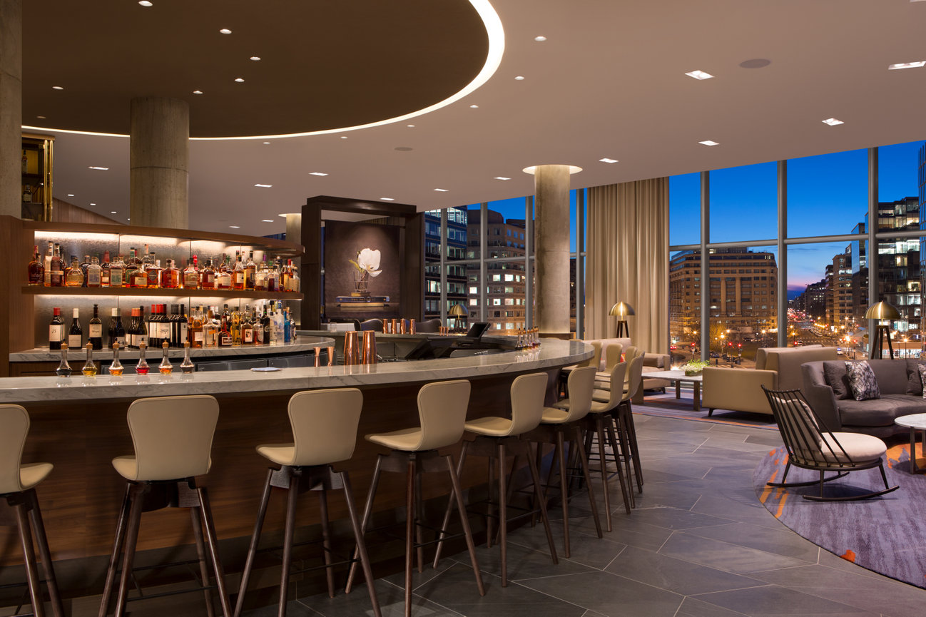 Circular Bar at The Conrad DC with a beautiful view of the city through wall to wall windows.
