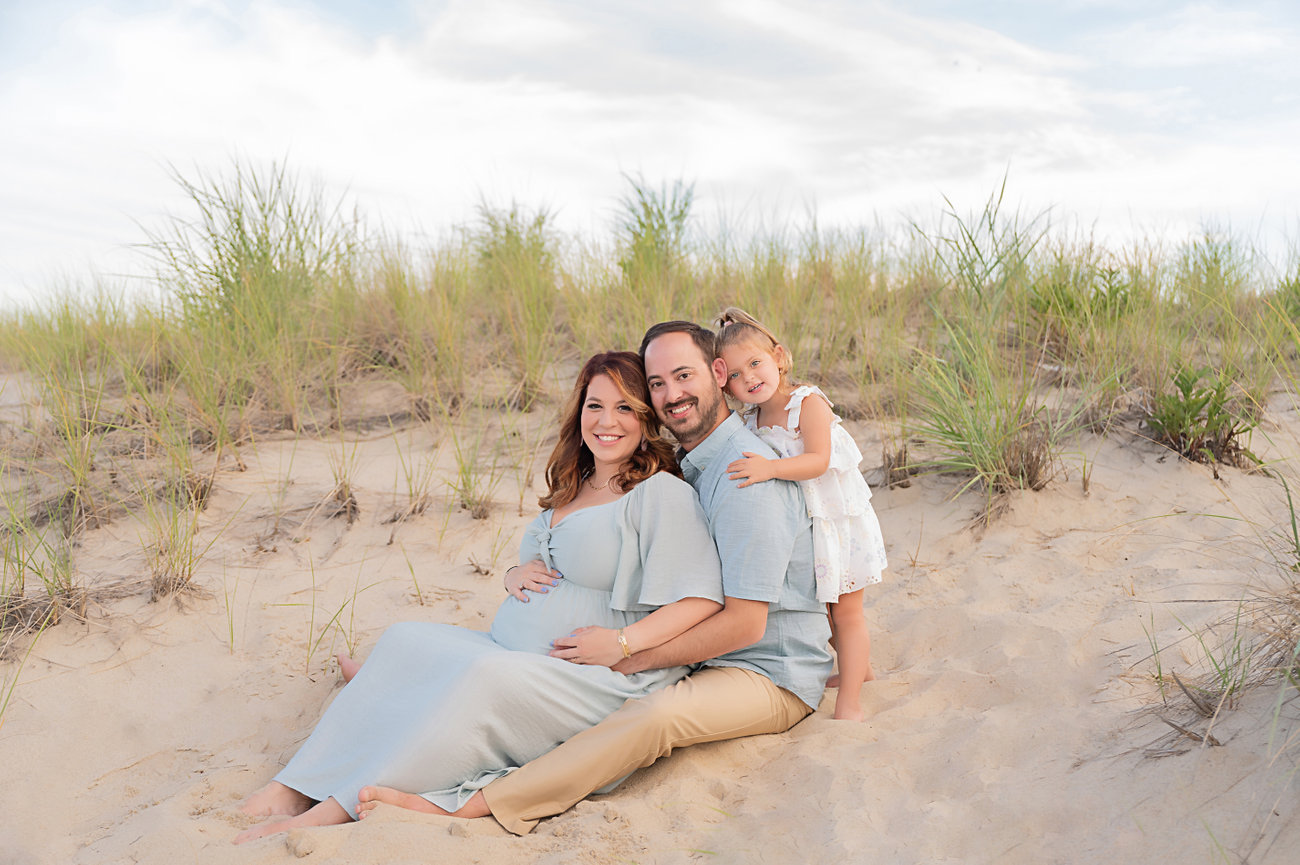 Beach family photo with grassy textures and golden sunlight