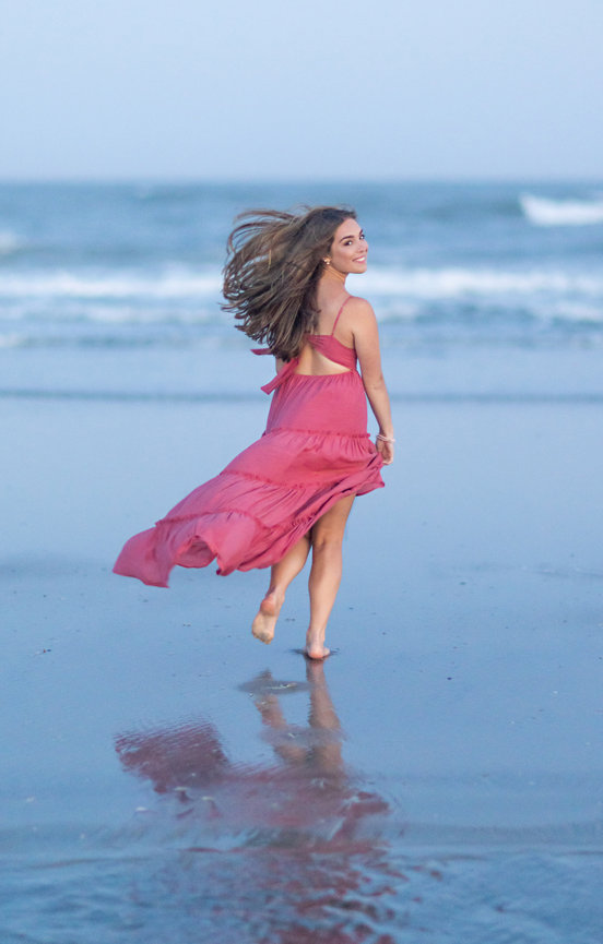 Pretty young woman running on the beach in Southern New Jersey