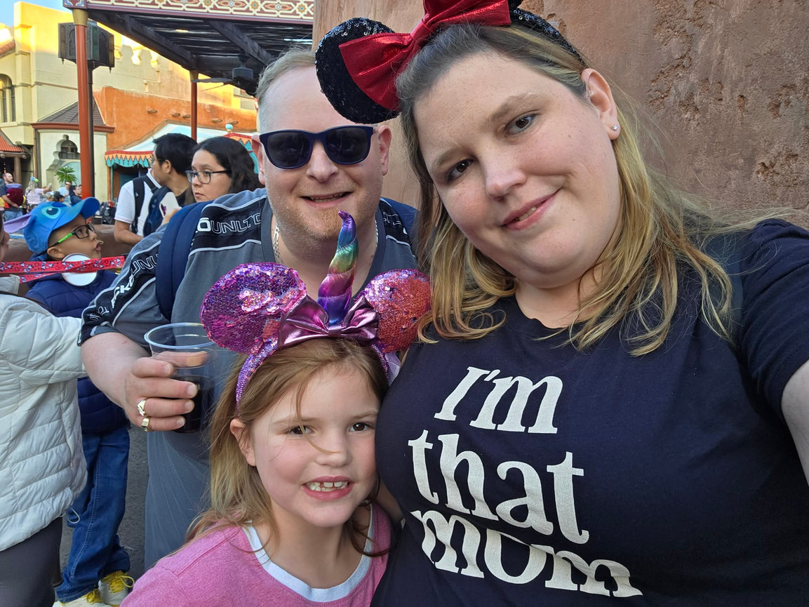 Family posing with amusement park decorations