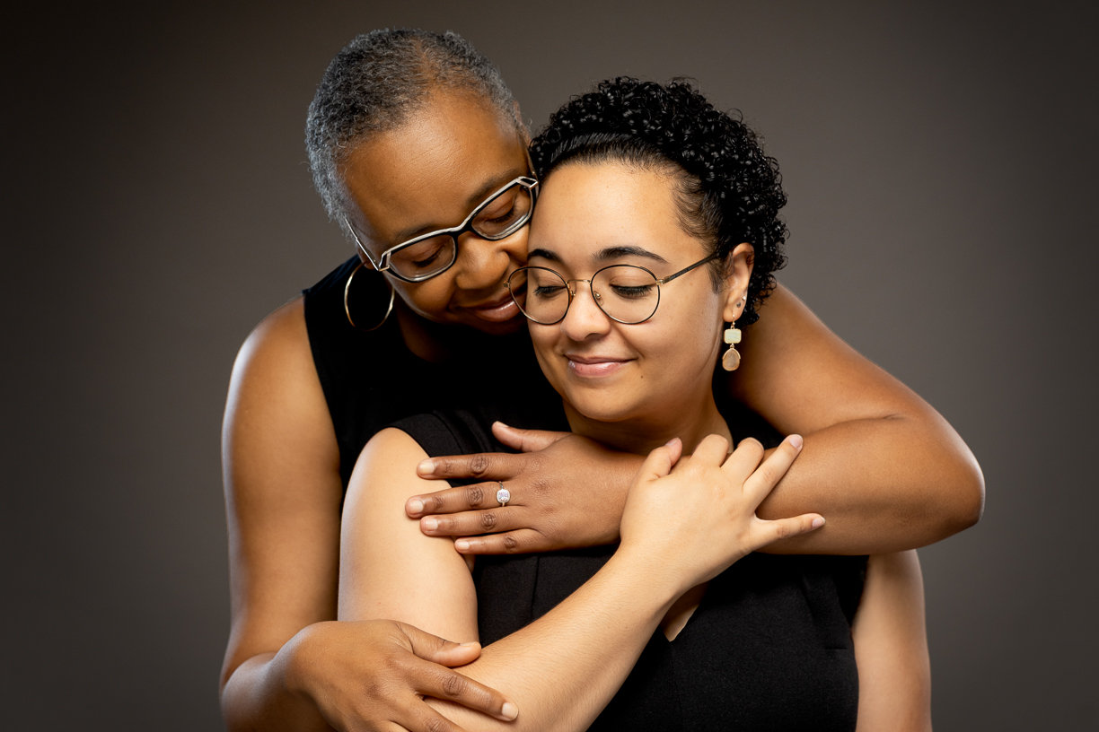Mom and daughter embrace in up-close studio portrait - Winnipeg Photography