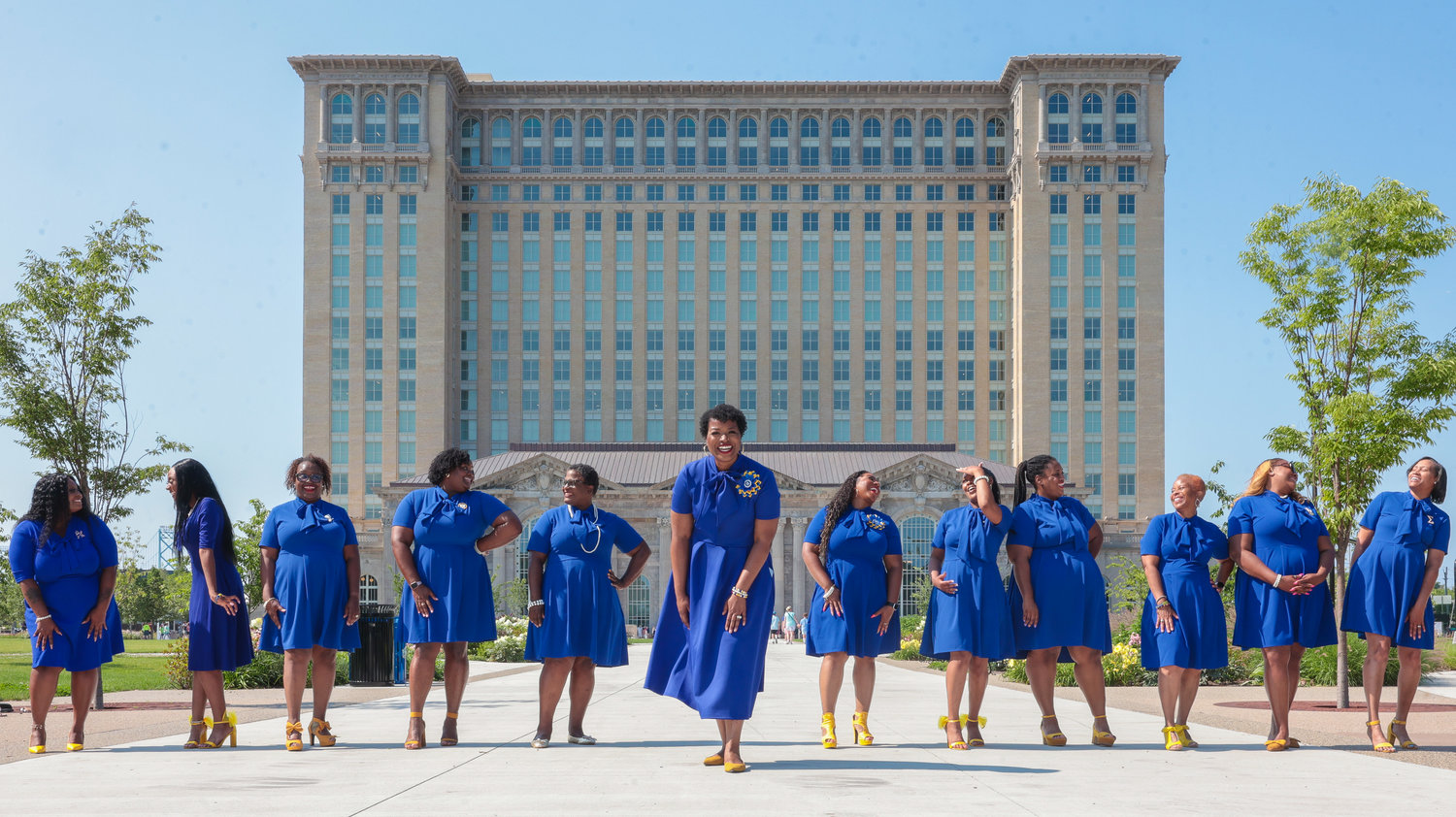 A group of people in blue uniforms standing in a line outdoors.