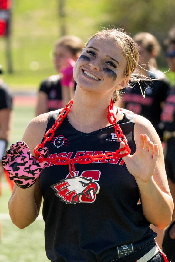 Cheerleader smiling and posing in a black and red uniform.