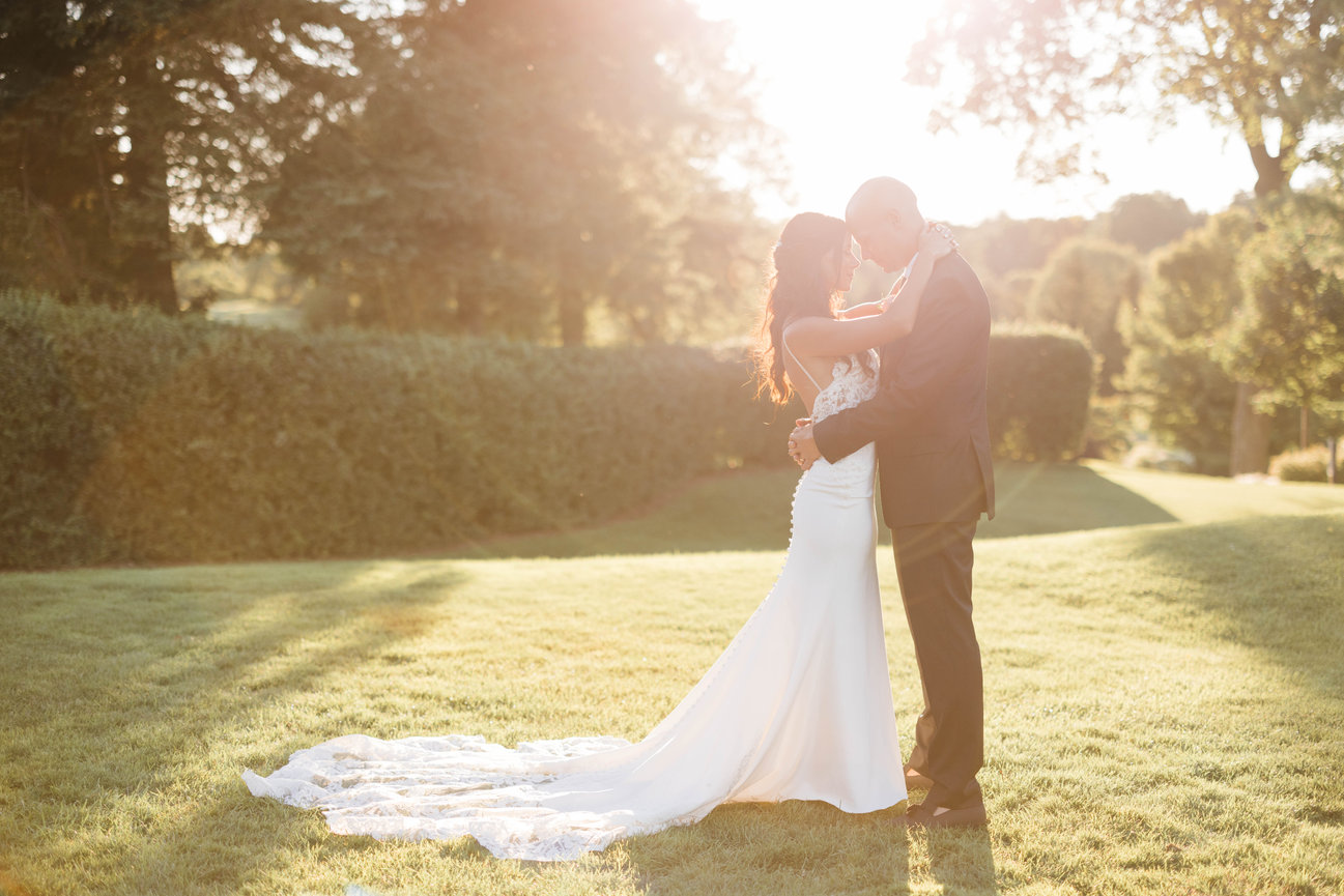 Bride and groom hugging at sunset at St Marys Golf Club, golden hour bride and groom photo at golf course.