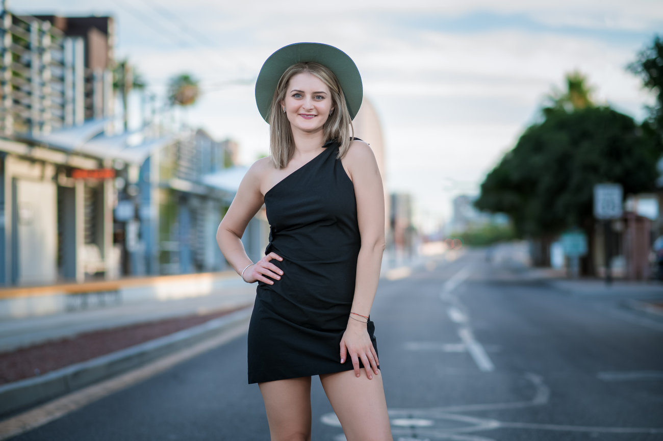 Senior girl standing in the middle of a downtown Phoenix street at sunrise