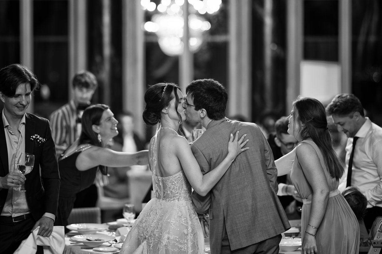 Bride and groom kissing during their wedding reception at Hôtel des Trois Couronnes in Vevey, Switzerland