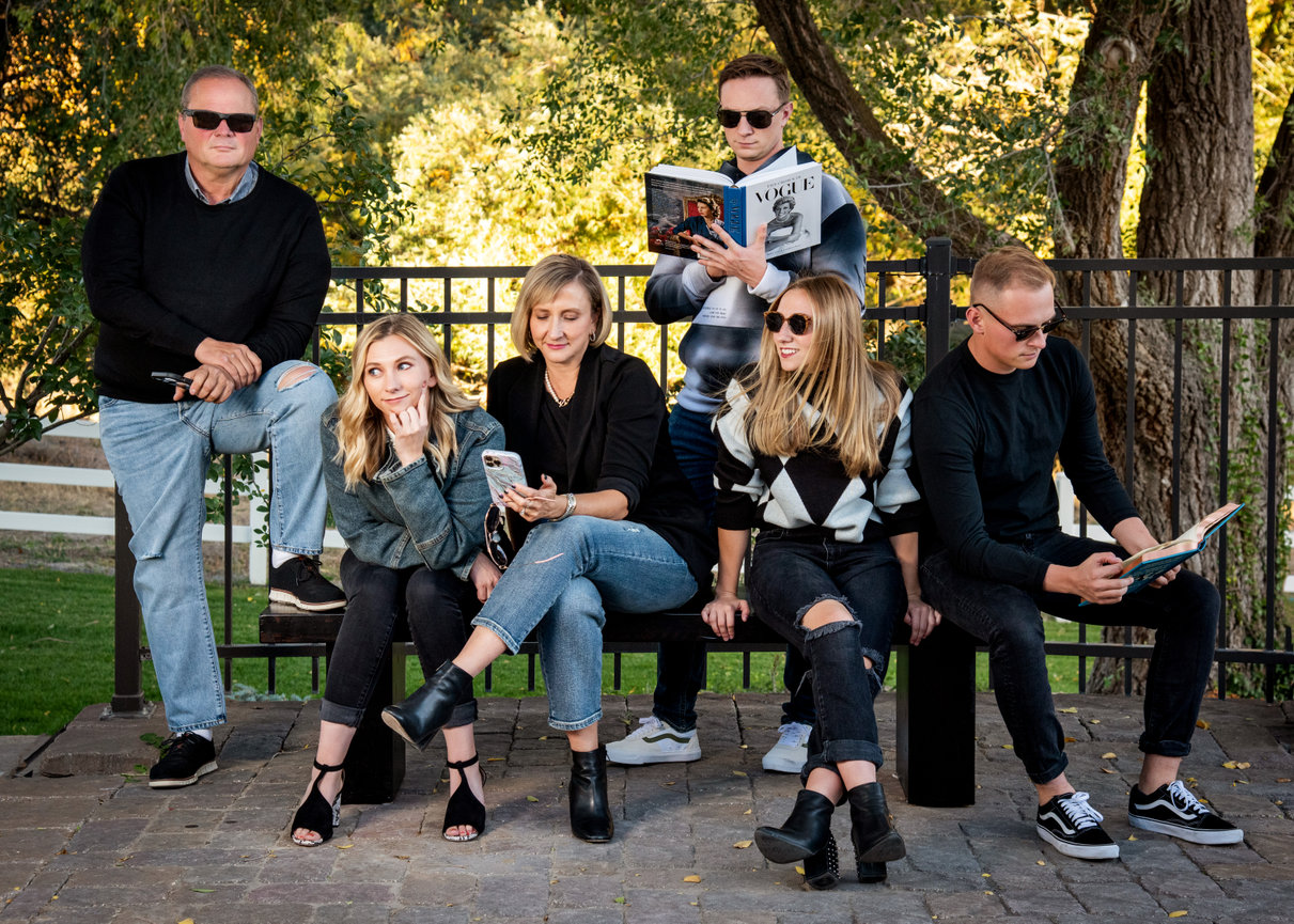 A fun family portrait with a family wearing sunglasses.