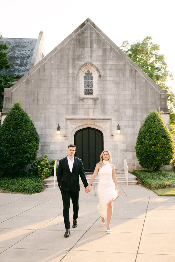 Engaged couple walking in Southside of Birmingham, Alabama. Engagement photography by Heather Durham.