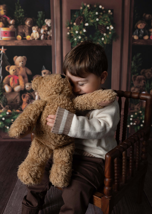 A little boy hugging his favorite teddy bear