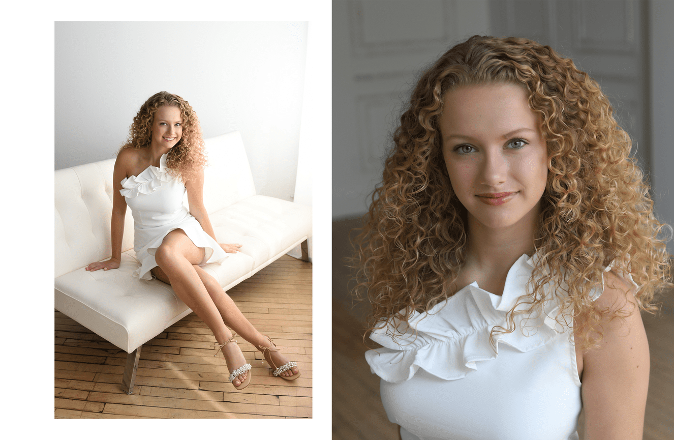 A young woman with spiral blonde hair and a white dress poses for her senior photos at Kliks Photography.
