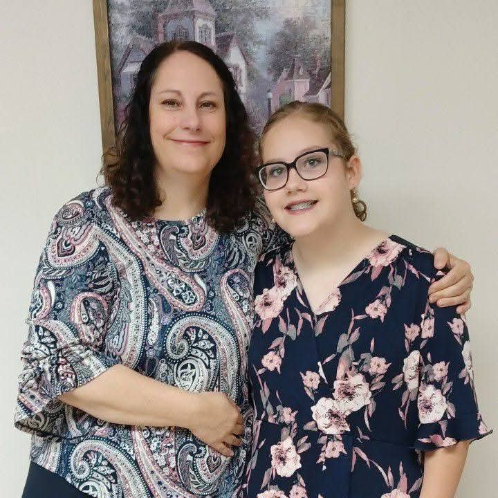 Two women smiling and posing for a portrait