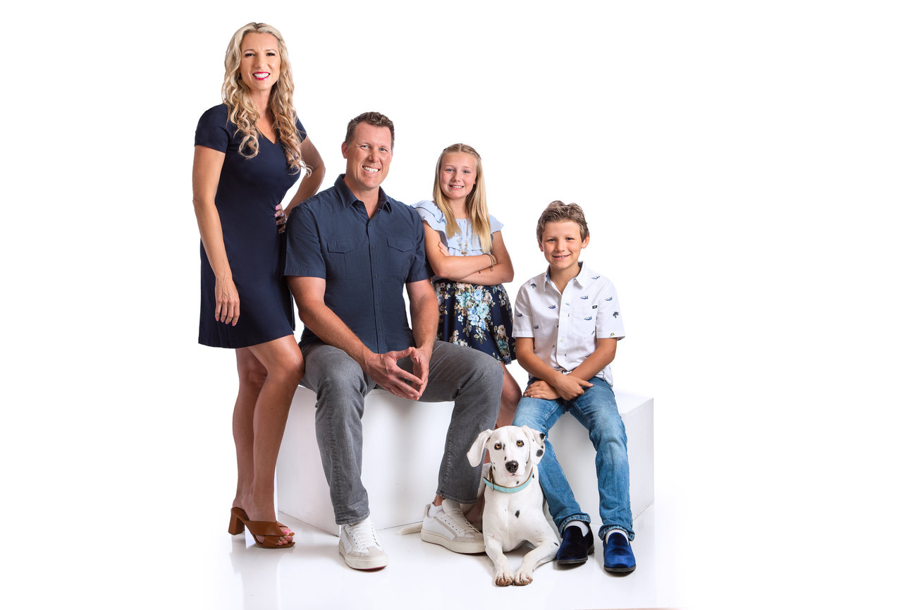 Instudio portrait of a family with their dalmation dog.