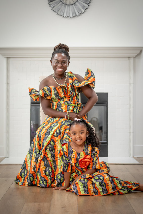 Mother and daughter in traditional attire indoors