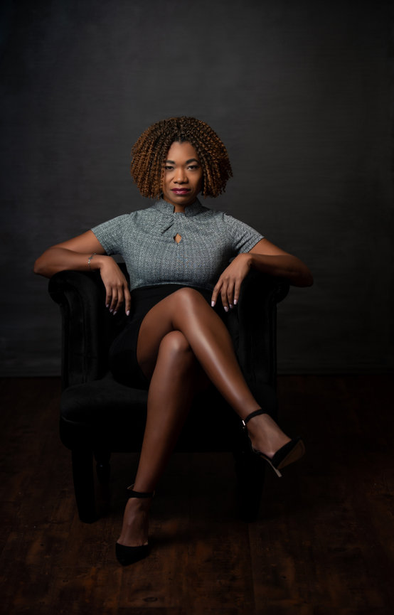Photo of Business Woman sitting in chair with legs crossed