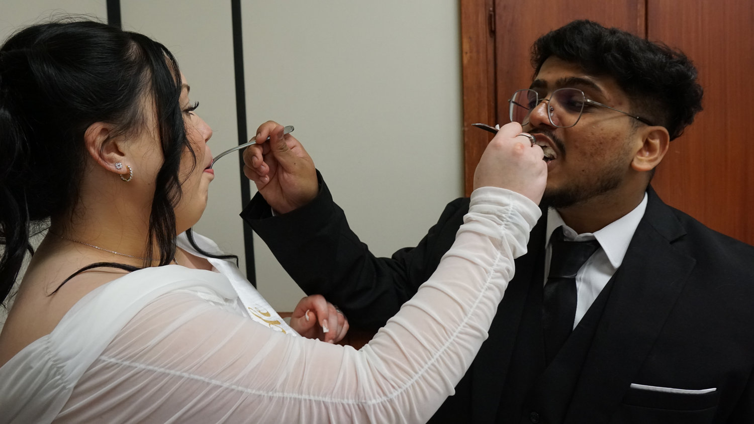 Bride and groom feeding each other at the reception